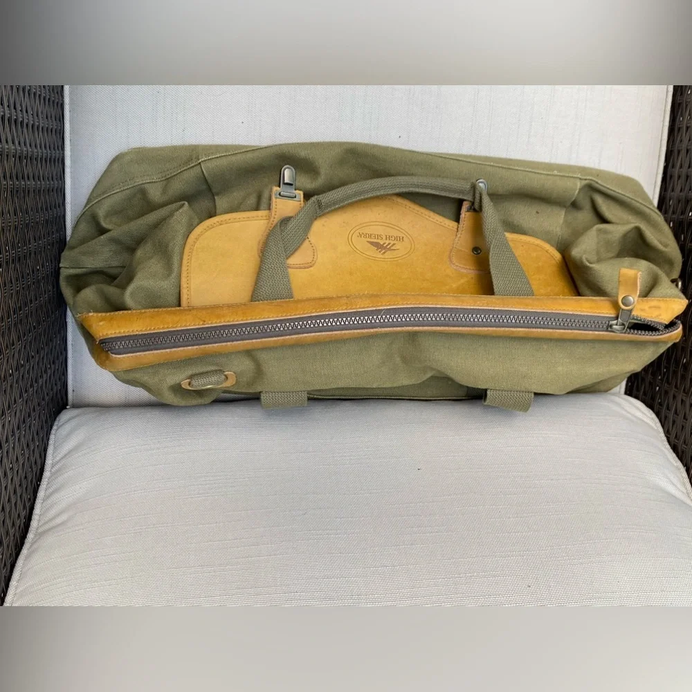Vintage like new High Sierra leather and green canvas duffle bag.
